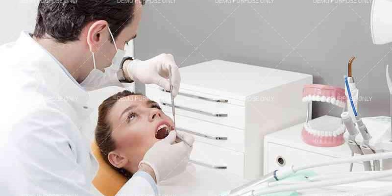 The dentist examines the patient mouth in Jacksonville Tx