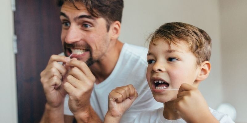 Father son doing teeth cleaning